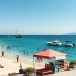 Napos tengerparton emberek pihennek és úsznak, Ksamil, Albánia