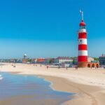 Warnemünde világítótorony a homokos tengerpart mellett